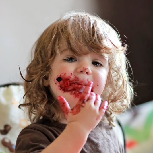 Toddler eating blueberry pie on Fathers Day
